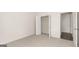 Empty bedroom featuring an open closet and doorway at 1940 Van Allen Ct # 12, Dacula, GA 30019