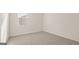An empty bedroom with gray carpet and a window with blinds at 1940 Van Allen Ct # 12, Dacula, GA 30019