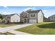 Two-story house with a brick and siding exterior, a well-maintained lawn, and a driveway at 1940 Van Allen Ct # 12, Dacula, GA 30019