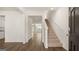 Hallway with wood-look floors and white walls, leading to the staircase and kitchen at 1940 Van Allen Ct # 12, Dacula, GA 30019
