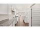 Modern kitchen featuring wood flooring, white cabinets, granite counters and an island with a sink at 1940 Van Allen Ct # 12, Dacula, GA 30019