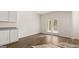 Open layout kitchen featuring wood floors, white cabinets, granite countertops, and access to the outdoors at 1940 Van Allen Ct # 12, Dacula, GA 30019