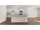 Modern kitchen featuring white cabinetry, granite countertops, stainless steel appliances, and hardwood floors with an open layout at 1940 Van Allen Ct # 12, Dacula, GA 30019