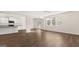 Open concept living room seamlessly connects to the kitchen, featuring wood-look flooring at 1940 Van Allen Ct # 12, Dacula, GA 30019