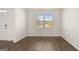 Inviting living room featuring wood-look floors, a large window, and neutral-colored walls at 1940 Van Allen Ct # 12, Dacula, GA 30019