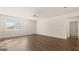 Spacious living room with wood-look flooring, ceiling fan, and a large window at 1940 Van Allen Ct # 12, Dacula, GA 30019
