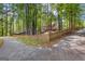 Spacious backyard with mature trees and a charming picket fence, offering both privacy and a touch of classic appeal at 226 Le Paradis Blvd, Sharpsburg, GA 30277