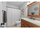 Bathroom featuring a single sink vanity, toilet, and shower with a curtain, providing essential amenities in a compact space at 226 Le Paradis Blvd, Sharpsburg, GA 30277