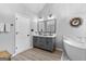 Bright bathroom showcases double vanity, soaking tub, and tile flooring, offering a serene and stylish retreat at 226 Le Paradis Blvd, Sharpsburg, GA 30277