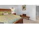 Comfortable bedroom featuring a bed, nightstand, and bench, offering a cozy and inviting space for rest and relaxation at 226 Le Paradis Blvd, Sharpsburg, GA 30277