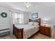 Cozy bedroom with a bed, bedside table, and window, creating a comfortable and inviting space for relaxation at 226 Le Paradis Blvd, Sharpsburg, GA 30277