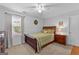 Bright bedroom with a bed, nightstand, and window, creating a cozy and inviting space for relaxation and rest at 226 Le Paradis Blvd, Sharpsburg, GA 30277