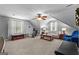 Spacious bonus room with multiple seating areas and a ceiling fan, ideal for relaxation, entertainment, or as a recreational space at 226 Le Paradis Blvd, Sharpsburg, GA 30277