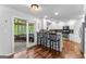 Modern kitchen featuring stainless steel appliances, breakfast bar, and access to the sunroom at 226 Le Paradis Blvd, Sharpsburg, GA 30277