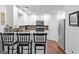 Updated kitchen with stainless steel appliances, sleek countertop, and breakfast bar seating at 226 Le Paradis Blvd, Sharpsburg, GA 30277