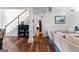 Spacious living room and foyer features hardwood floors, staircase and view of other rooms at 226 Le Paradis Blvd, Sharpsburg, GA 30277
