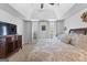 Spacious main bedroom with a tray ceiling, large bed and furniture at 226 Le Paradis Blvd, Sharpsburg, GA 30277