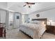 Bright main bedroom features a large bed, ceiling fan, and ample natural light from windows at 226 Le Paradis Blvd, Sharpsburg, GA 30277