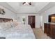 Cozy main bedroom featuring a tray ceiling, furniture and walk-in closet at 226 Le Paradis Blvd, Sharpsburg, GA 30277
