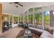 Charming sunroom featuring comfortable seating with picturesque views of the lake at 226 Le Paradis Blvd, Sharpsburg, GA 30277