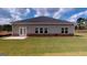 Spacious backyard with lush green lawn and a brick-trimmed patio, perfect for outdoor gatherings at 1278 Hollingsworth Way # 39, Dacula, GA 30019
