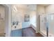 Bright bathroom featuring double sinks, a bathtub, and separate glass-enclosed shower at 1278 Hollingsworth Way # 39, Dacula, GA 30019