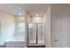 Bright bathroom featuring a bathtub and separate glass-enclosed shower at 1278 Hollingsworth Way # 39, Dacula, GA 30019