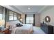 Comfortable bedroom with natural light, neutral colors, and upholstered bed and carpet flooring at 1278 Hollingsworth Way # 39, Dacula, GA 30019