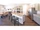 Modern kitchen featuring granite countertops, stainless steel appliances, a central island, and wooden floors at 1278 Hollingsworth Way # 39, Dacula, GA 30019