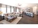 Open-concept living room with large sectional, kitchen island, and hardwood floors at 1278 Hollingsworth Way # 39, Dacula, GA 30019