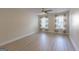 This bedroom features a ceiling fan, light-colored walls, and two windows at 701 Ridgelake Dr, Peachtree City, GA 30269