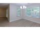 Bright dining area with modern chandelier and scenic outdoor views at 701 Ridgelake Dr, Peachtree City, GA 30269