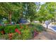Community entrance sign with lush greenery and flowers at 701 Ridgelake Dr, Peachtree City, GA 30269