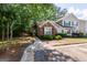 Inviting townhome with brick accents and lush landscaping leading to a welcoming entrance and adjacent parking at 701 Ridgelake Dr, Peachtree City, GA 30269
