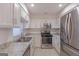 Kitchen with modern appliances, granite countertops and white subway tile backsplash at 701 Ridgelake Dr, Peachtree City, GA 30269