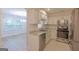 Well-equipped kitchen featuring stainless appliances, stone countertops, and an adjoining living space at 701 Ridgelake Dr, Peachtree City, GA 30269