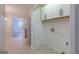 Laundry room with built in cabinets, tile floor and utility connections at 701 Ridgelake Dr, Peachtree City, GA 30269