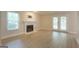 Bright living room featuring a classic fireplace, ample natural light, and vinyl plank flooring at 701 Ridgelake Dr, Peachtree City, GA 30269