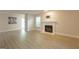 Living room showcases stylish fireplace, new flooring, and direct access to the back patio at 701 Ridgelake Dr, Peachtree City, GA 30269