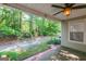 View of the backyard from the covered patio with ceiling fan at 701 Ridgelake Dr, Peachtree City, GA 30269