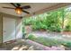 Covered patio with ceiling fan overlooking a wooded backyard at 701 Ridgelake Dr, Peachtree City, GA 30269