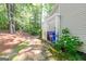 View of the side yard with garbage bins and a stone pathway at 701 Ridgelake Dr, Peachtree City, GA 30269