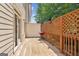 Outdoor deck with wood railing, wooden floor, and red grill at 1106 Bakary Ct, Decatur, GA 30032