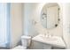 Cozy bathroom with a pedestal sink, round mirror, and neutral paint at 1106 Bakary Ct, Decatur, GA 30032