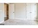 Empty bedroom with neutral carpet, neutral paint, and white doors at 1106 Bakary Ct, Decatur, GA 30032