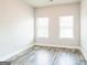 Bright bedroom featuring gray wood floors and two windows for natural light at 1106 Bakary Ct, Decatur, GA 30032