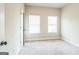 Bedroom with neutral carpet, white trim, and two windows with blinds at 1106 Bakary Ct, Decatur, GA 30032