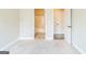 Empty bedroom with neutral carpet, neutral paint, and view to a bathroom at 1106 Bakary Ct, Decatur, GA 30032
