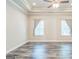 Bedroom featuring wood floors, large windows, and decorative ceiling at 1106 Bakary Ct, Decatur, GA 30032