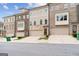 Modern townhome featuring a brick and siding exterior with attached garages at 1106 Bakary Ct, Decatur, GA 30032